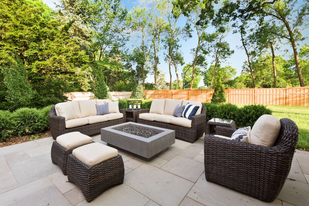 outdoor patio area with comfortable seating around a gas firepit