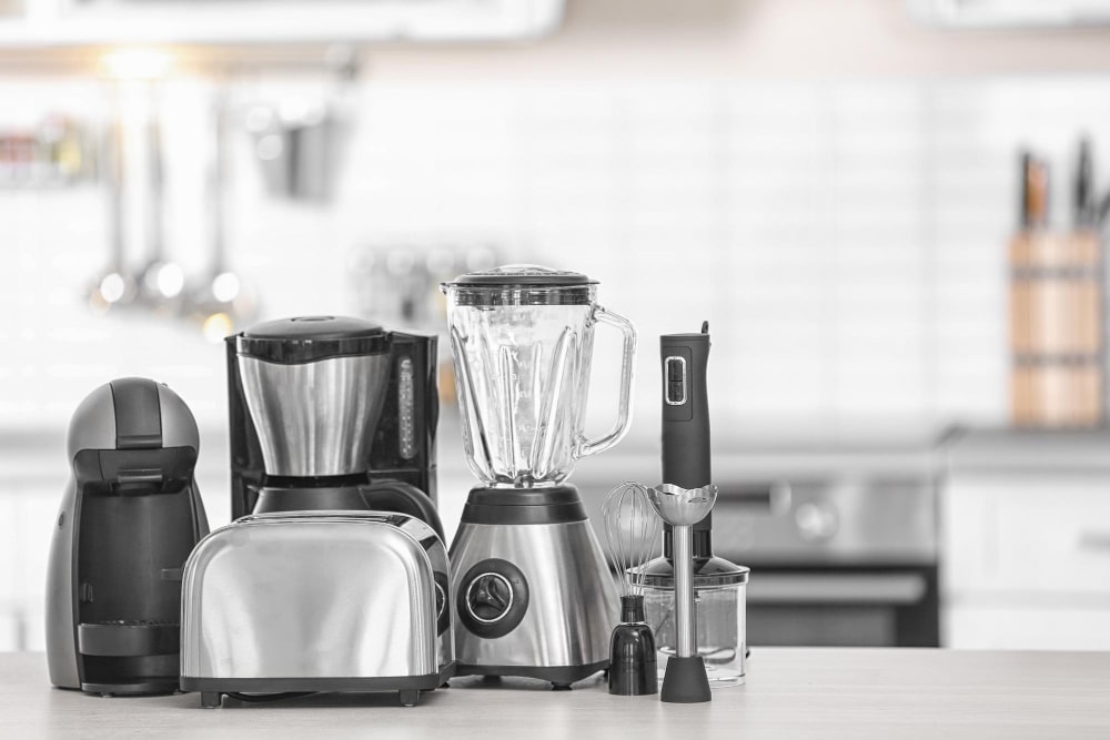 Variety of small kitchen appliances featuring a toaster, coffee maker, and blender, showcasing their essential roles in simplifying meal prep and enhancing everyday cooking.