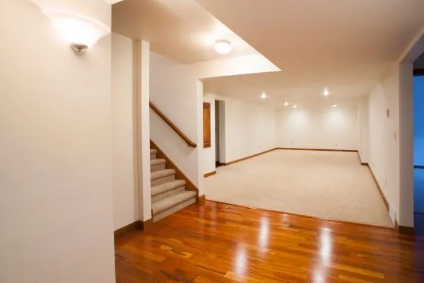 spacious finished basement with carpet and hardwood flooring