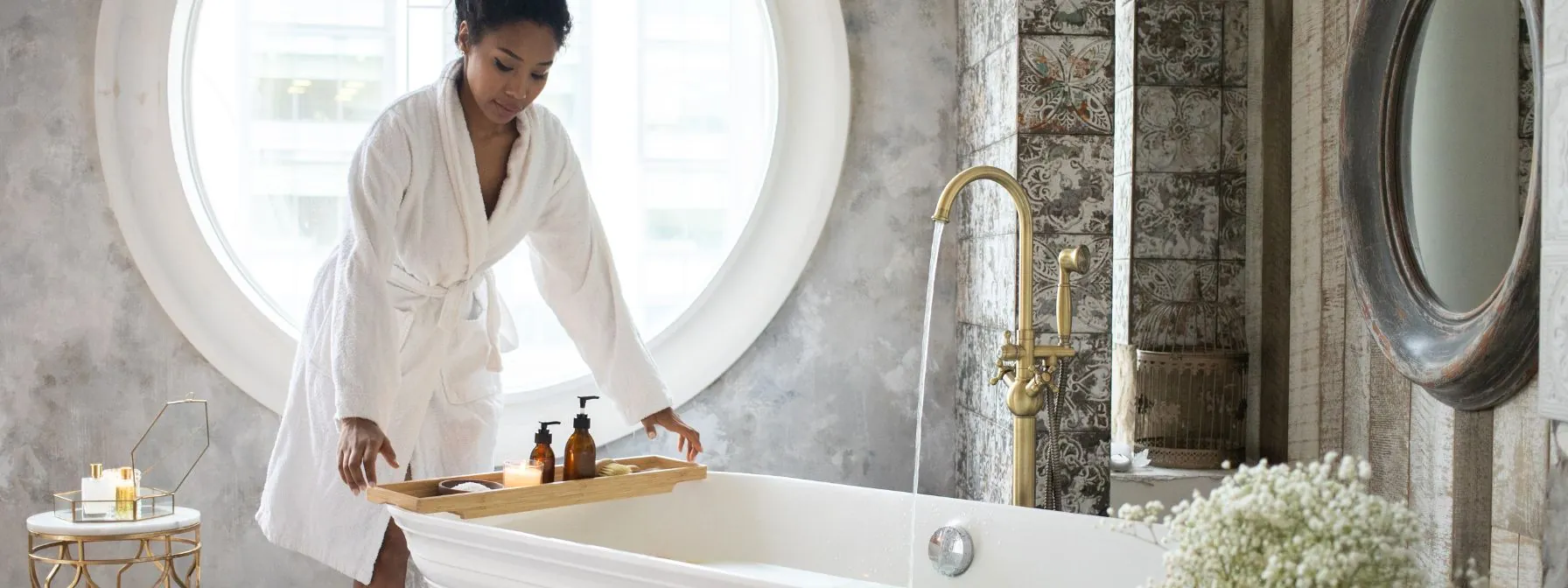 black woman with spa products in bathroom