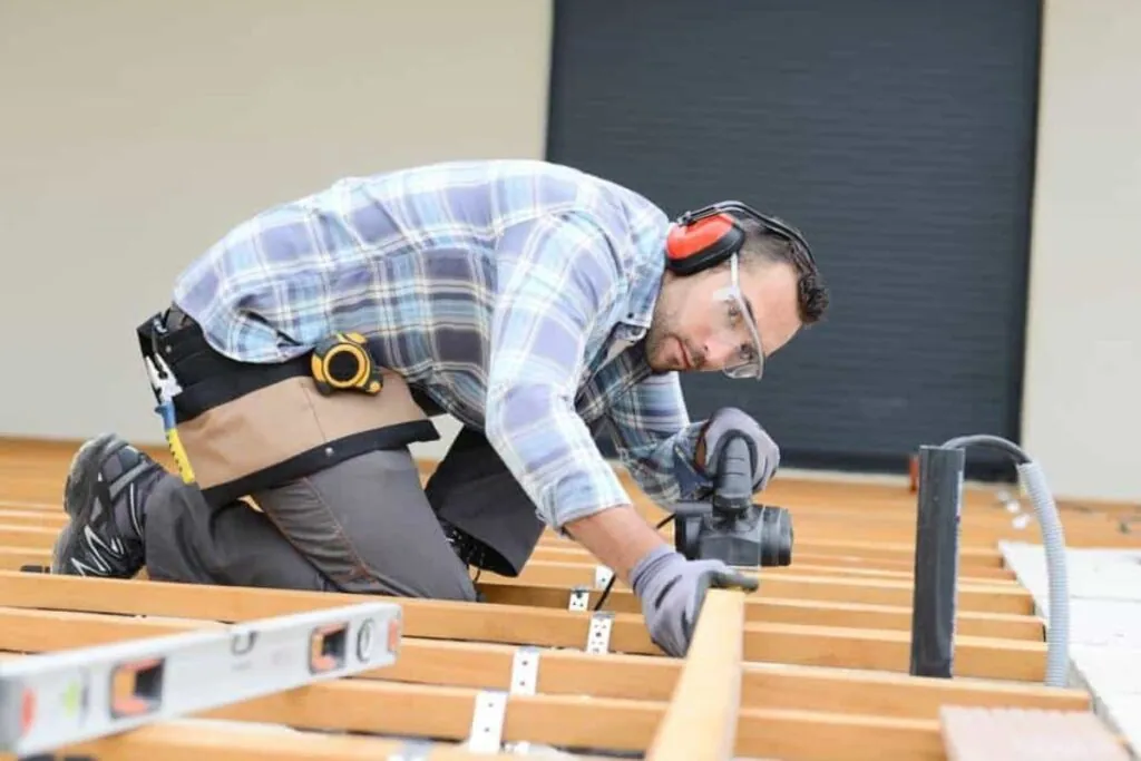 deck builder working on an outdoor deck renovation in Newton MA