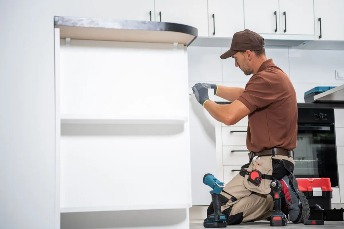 home remodeling contractor finishing kitchen cabinet installation in Waltham MA