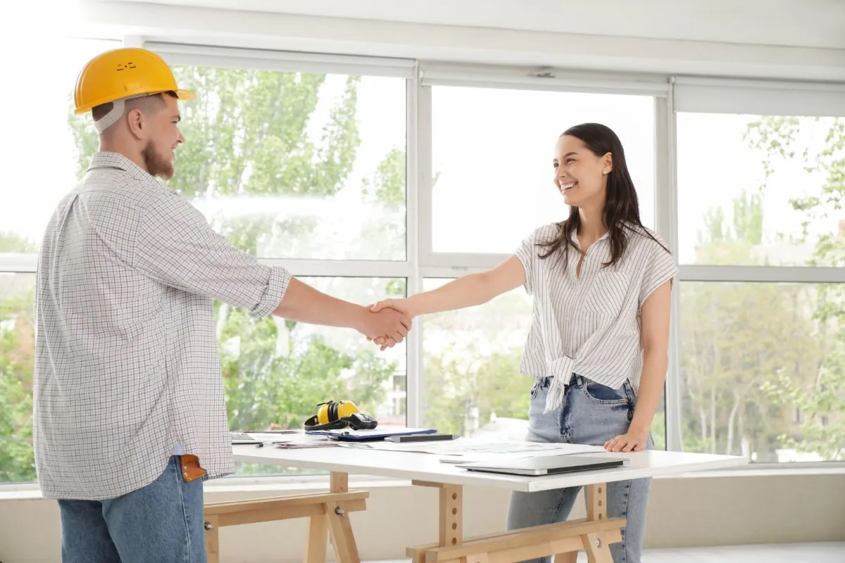 satisfied client shaking hands with male contractor for home remodeling project in Waltham MA